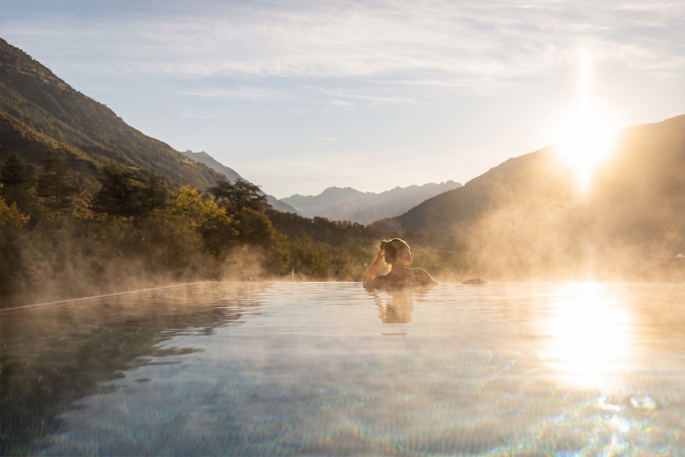 Misty infinity pool overlooking the mountains at sunrise